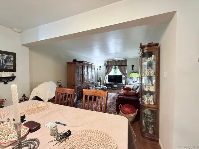 a living room with furniture a chandelier and a wooden floor