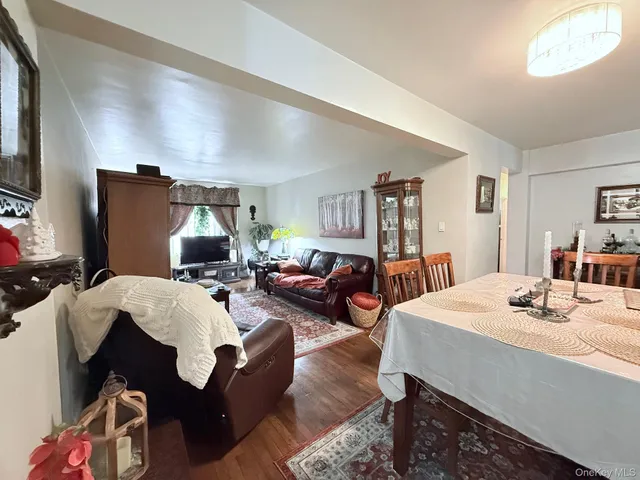a living room with furniture a flat screen tv and a table