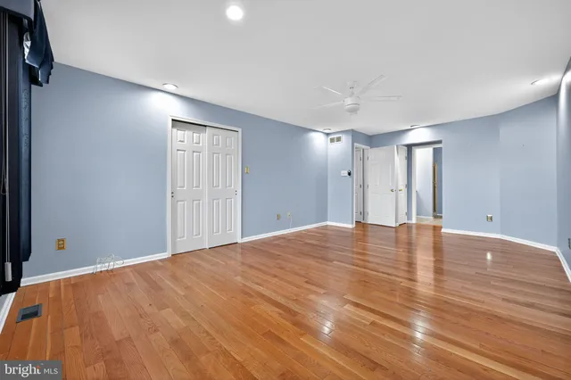 a view of empty room with wooden floor