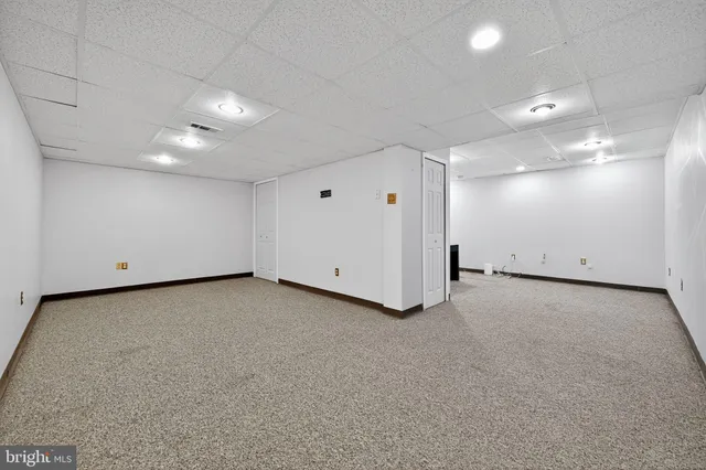 a view of a room with window and ceiling fan