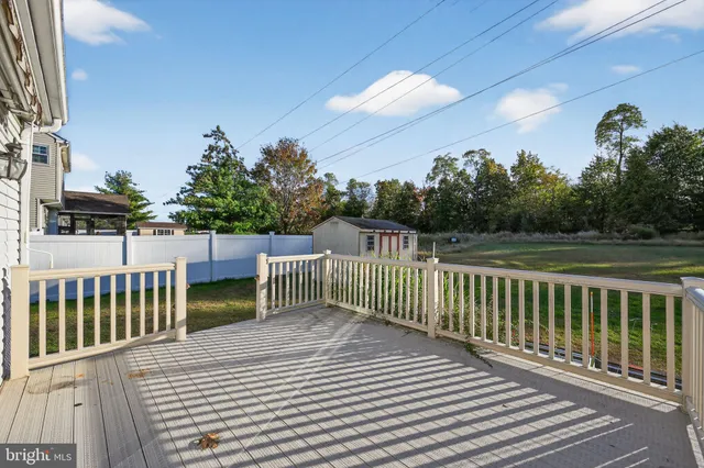 a view of a balcony with wooden floor and fence