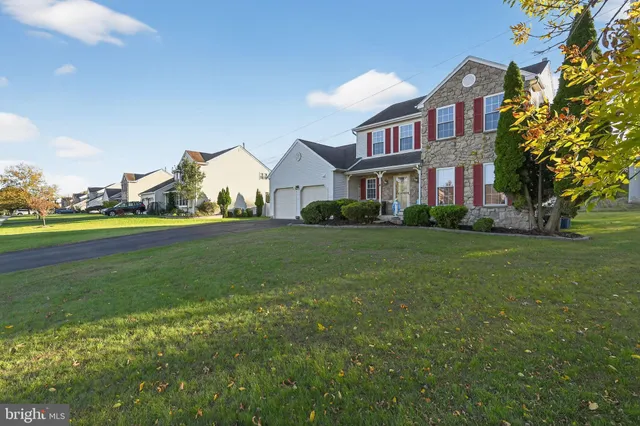 a front view of house with yard and green space