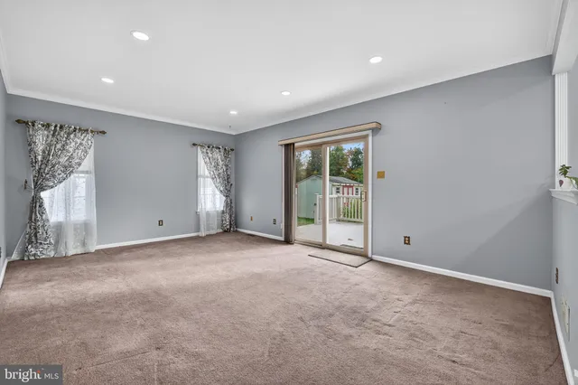 a view of an empty room with glass door