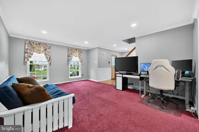 a bedroom with furniture and a flat screen tv
