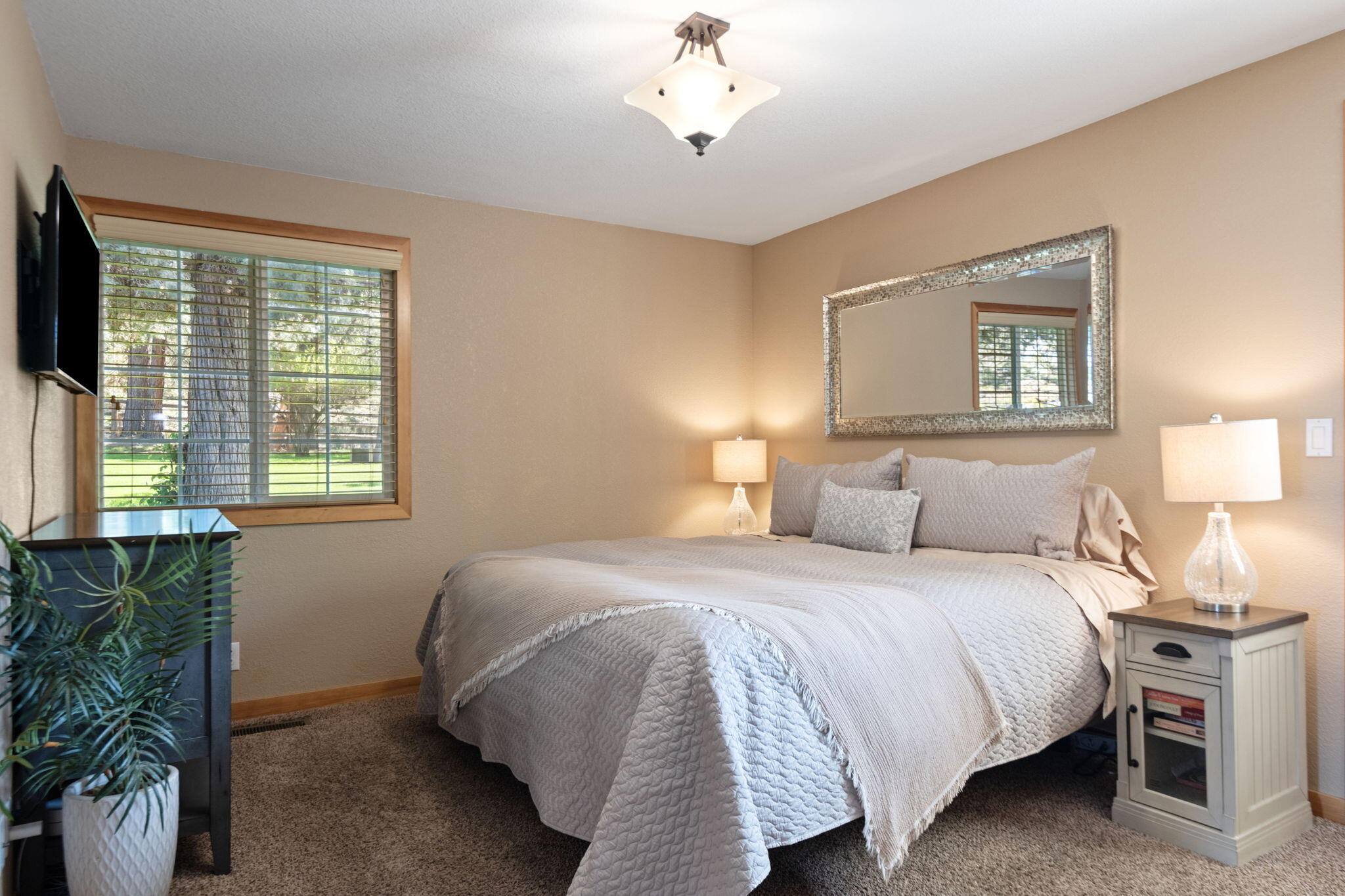 22539 Martee Lane Bend, OR 97701 - Photo 13 of 54 a bedroom with a bed and a chandelier