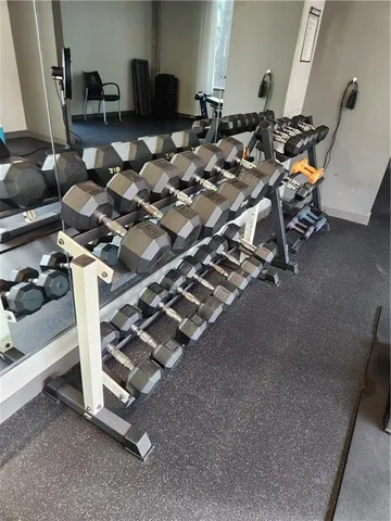 a dining room with furniture and a floor to ceiling window