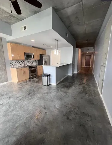 a view of a kitchen with a sink and a stove top oven