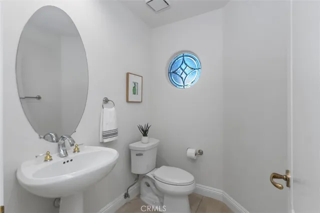 a bathroom with a sink mirror and toilet