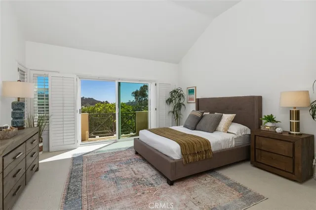a bedroom with a bed and large window