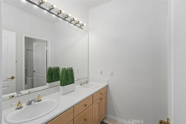 a bathroom with a double vanity sink and a mirror