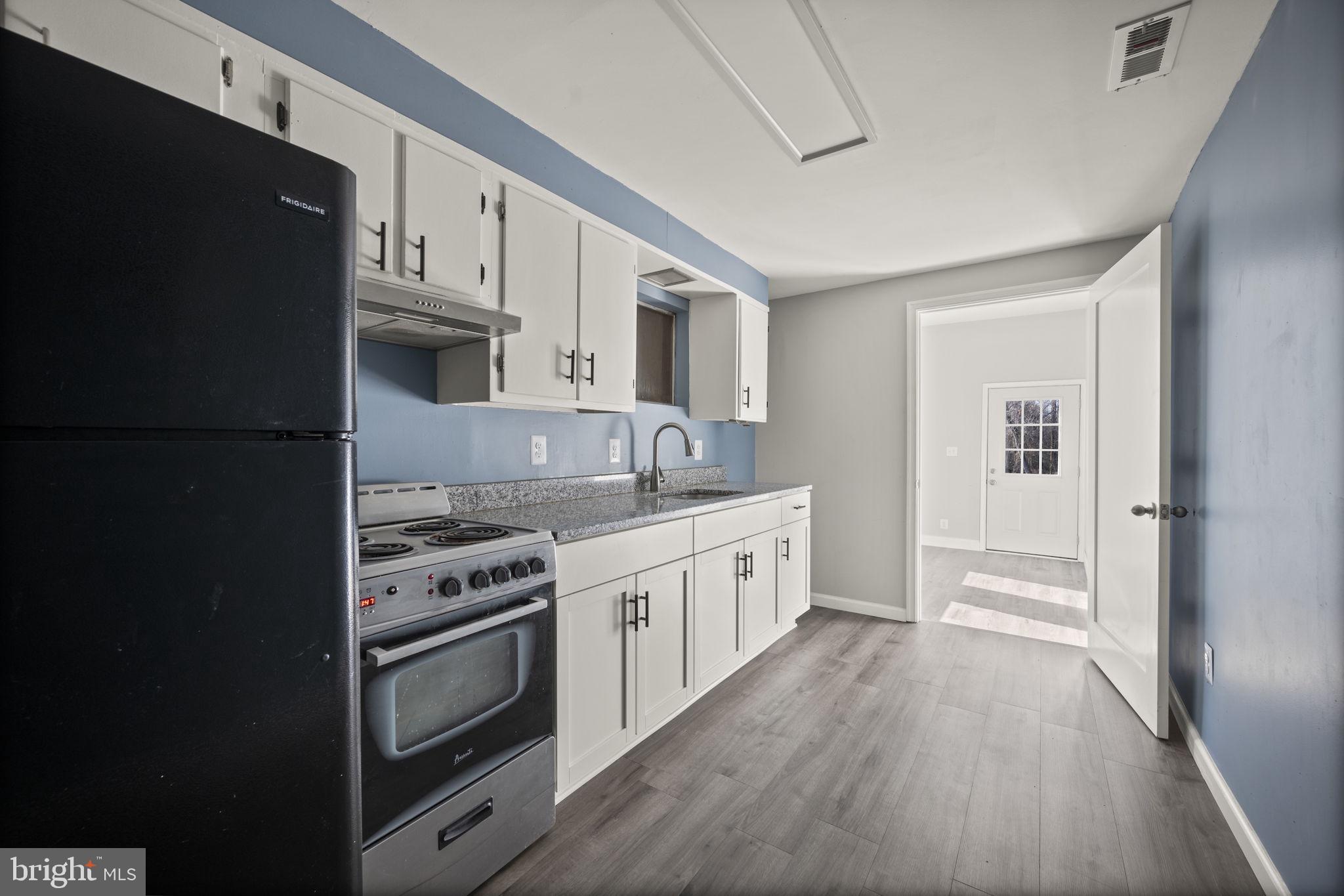 10412 Vincent Road White Marsh, MD 21162 - Photo 14 of 65 a kitchen with stainless steel appliances a stove a sink and a refrigerator