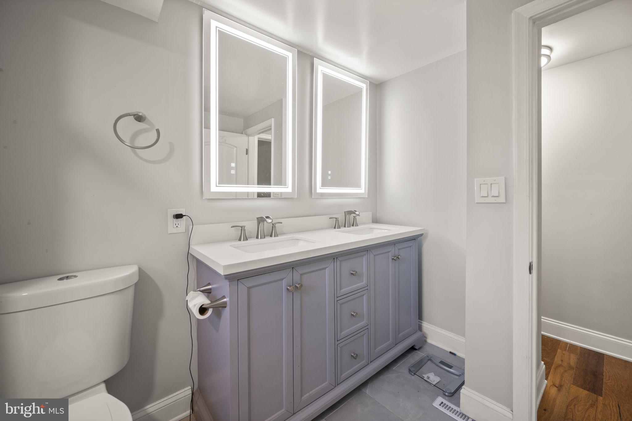 10412 Vincent Road White Marsh, MD 21162 - Photo 19 of 65 a bathroom with a sink a toilet and a mirror