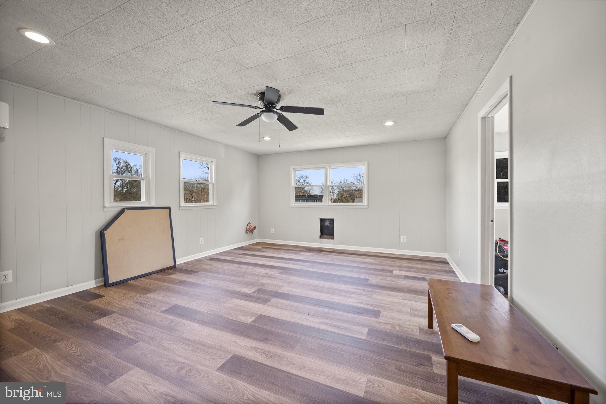 10412 Vincent Road White Marsh, MD 21162 - Photo 22 of 65 a view of empty room with wooden floor and fan