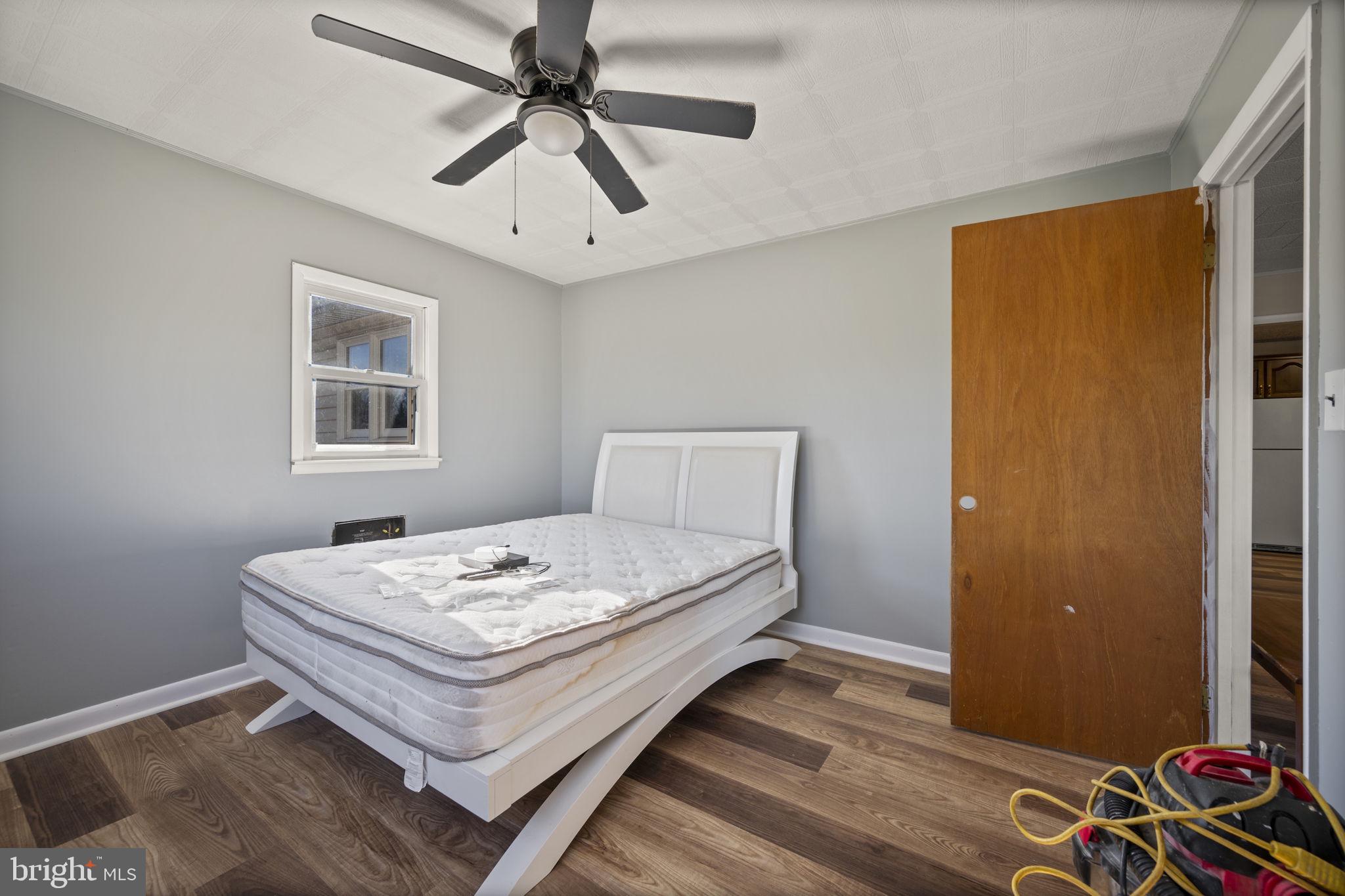 10412 Vincent Road White Marsh, MD 21162 - Photo 25 of 65 a bedroom with a bed and a window