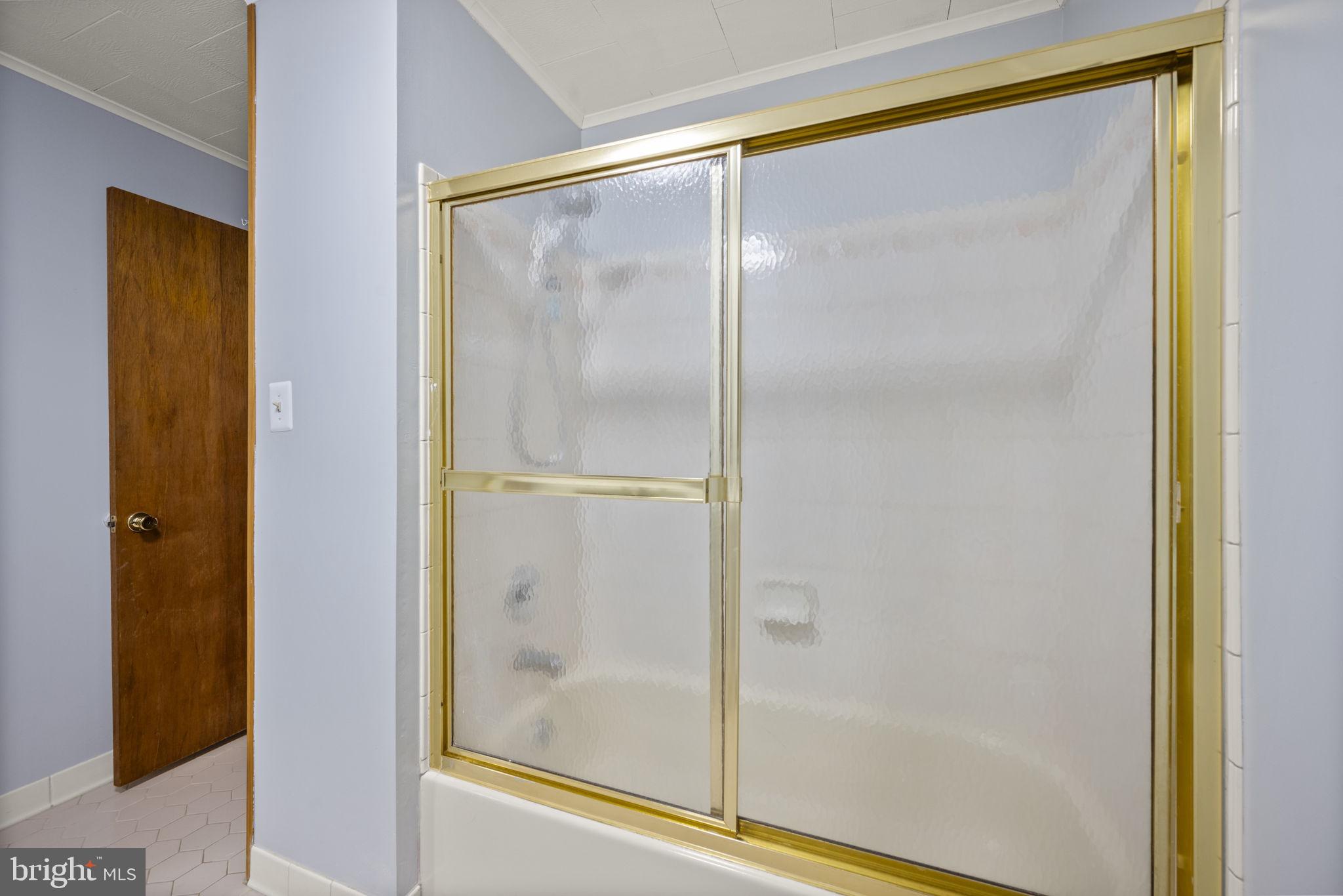 10412 Vincent Road White Marsh, MD 21162 - Photo 32 of 65 a bathroom with a glass shower door