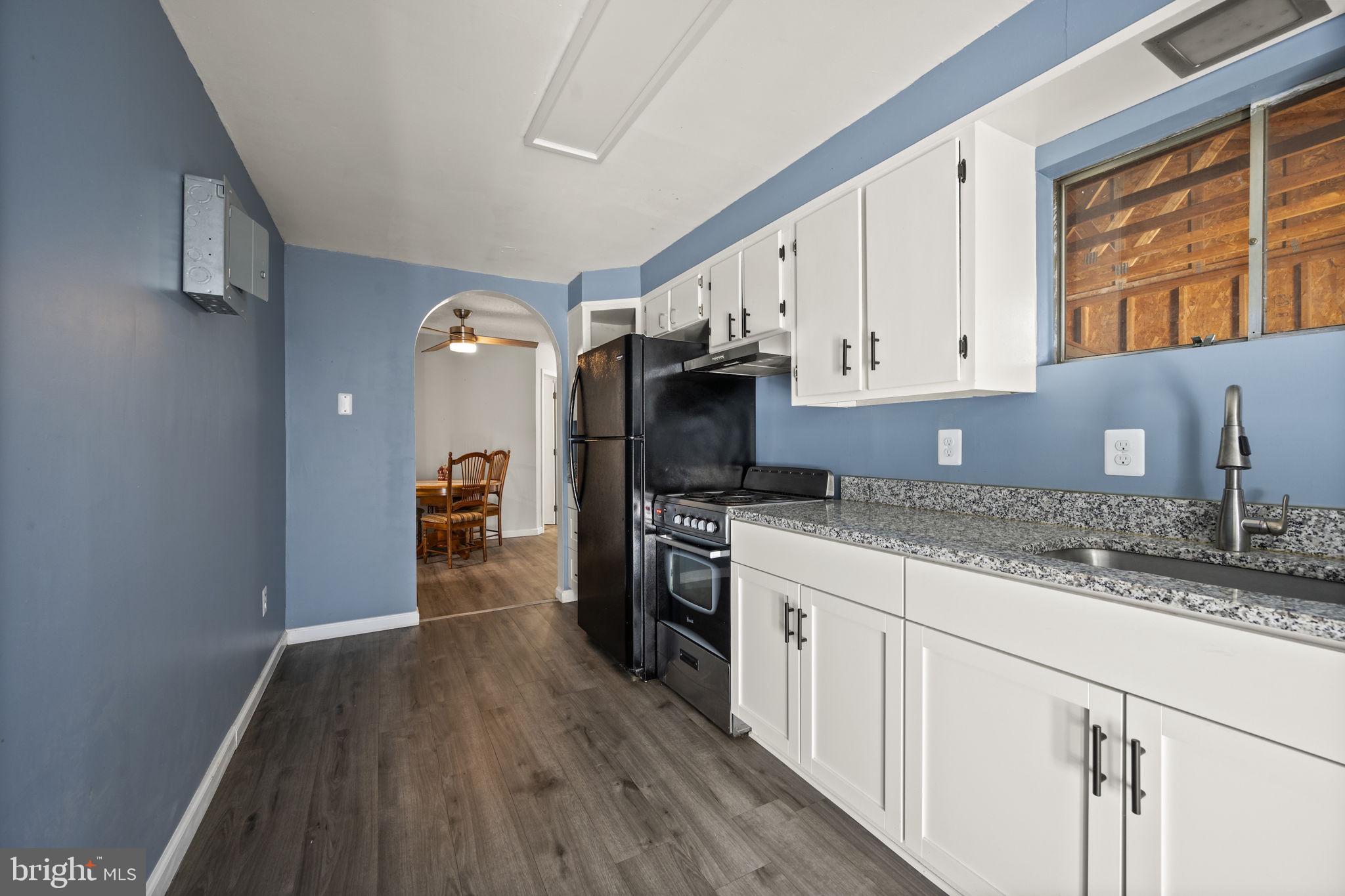 10412 Vincent Road White Marsh, MD 21162 - Photo 36 of 65 a kitchen with granite countertop a sink cabinets stainless steel appliances and a counter space