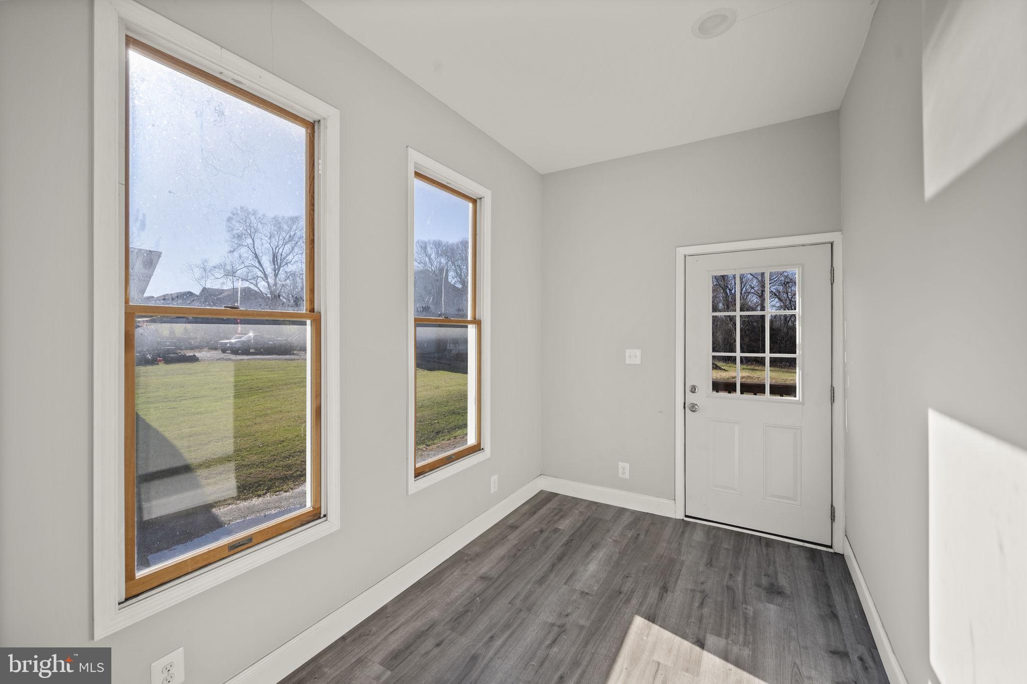 10412 Vincent Road White Marsh, MD 21162 - Photo 37 of 65 an empty room with wooden floor and a window