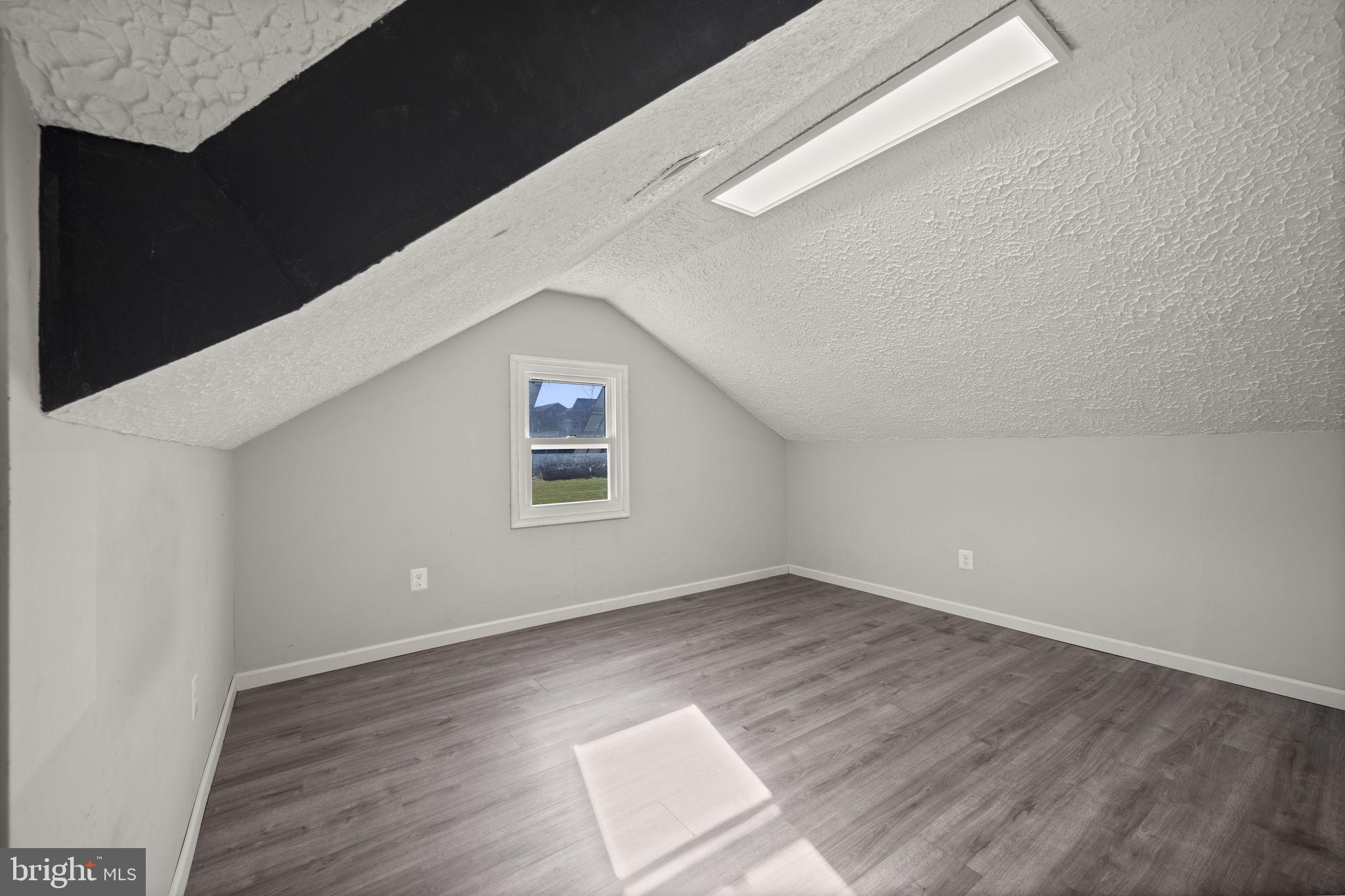 10412 Vincent Road White Marsh, MD 21162 - Photo 44 of 65 a view of an empty room with wooden floor and a window