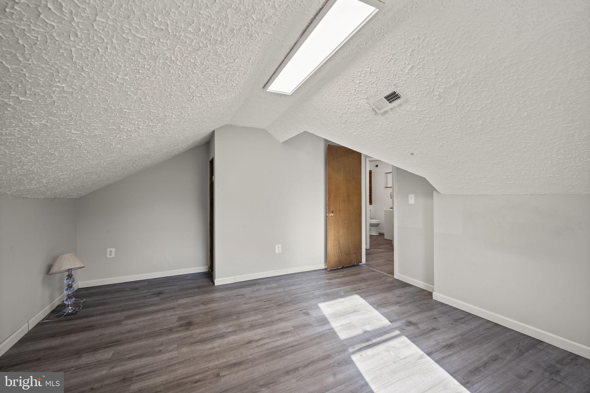 10412 Vincent Road White Marsh, MD 21162 - Photo 45 of 65 a view of an empty room with wooden floor