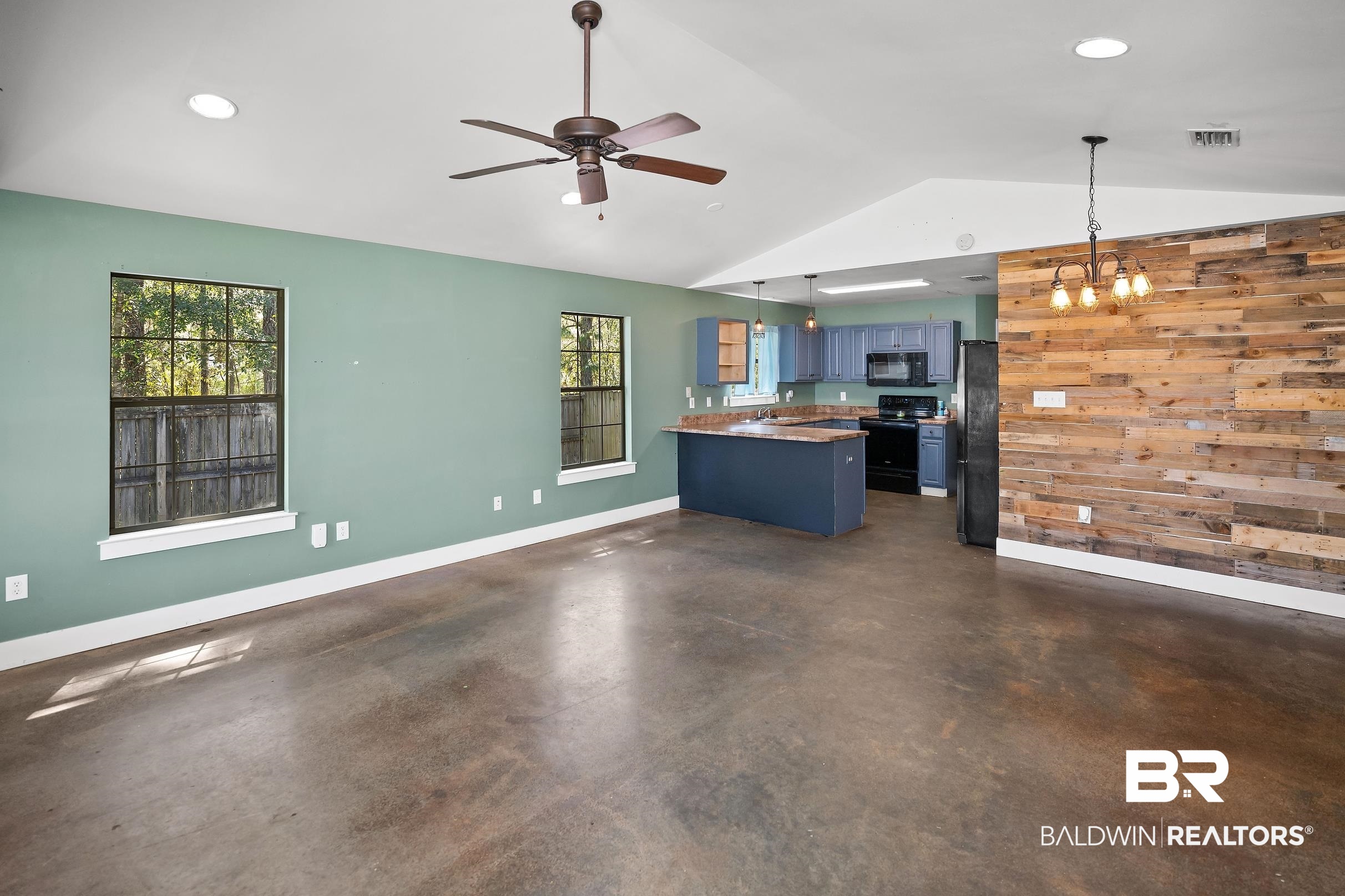 2000 Maria Lane Lillian, AL 36549 - Photo 5 of 35 Kitchen featuring wood walls, blue cabinetry, a peninsula, black appliances, and ceiling fan