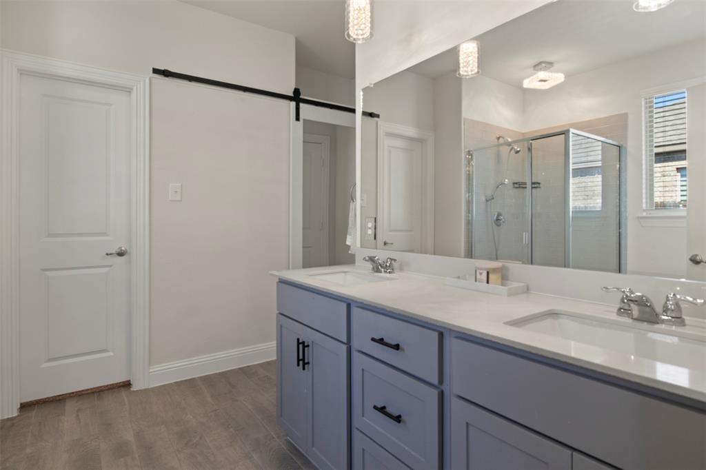 4125 Fern Loop Forney, TX 75126 - Photo 15 of 40 Dual vanity with light gray cabinetry, white countertops, and chrome fixtures