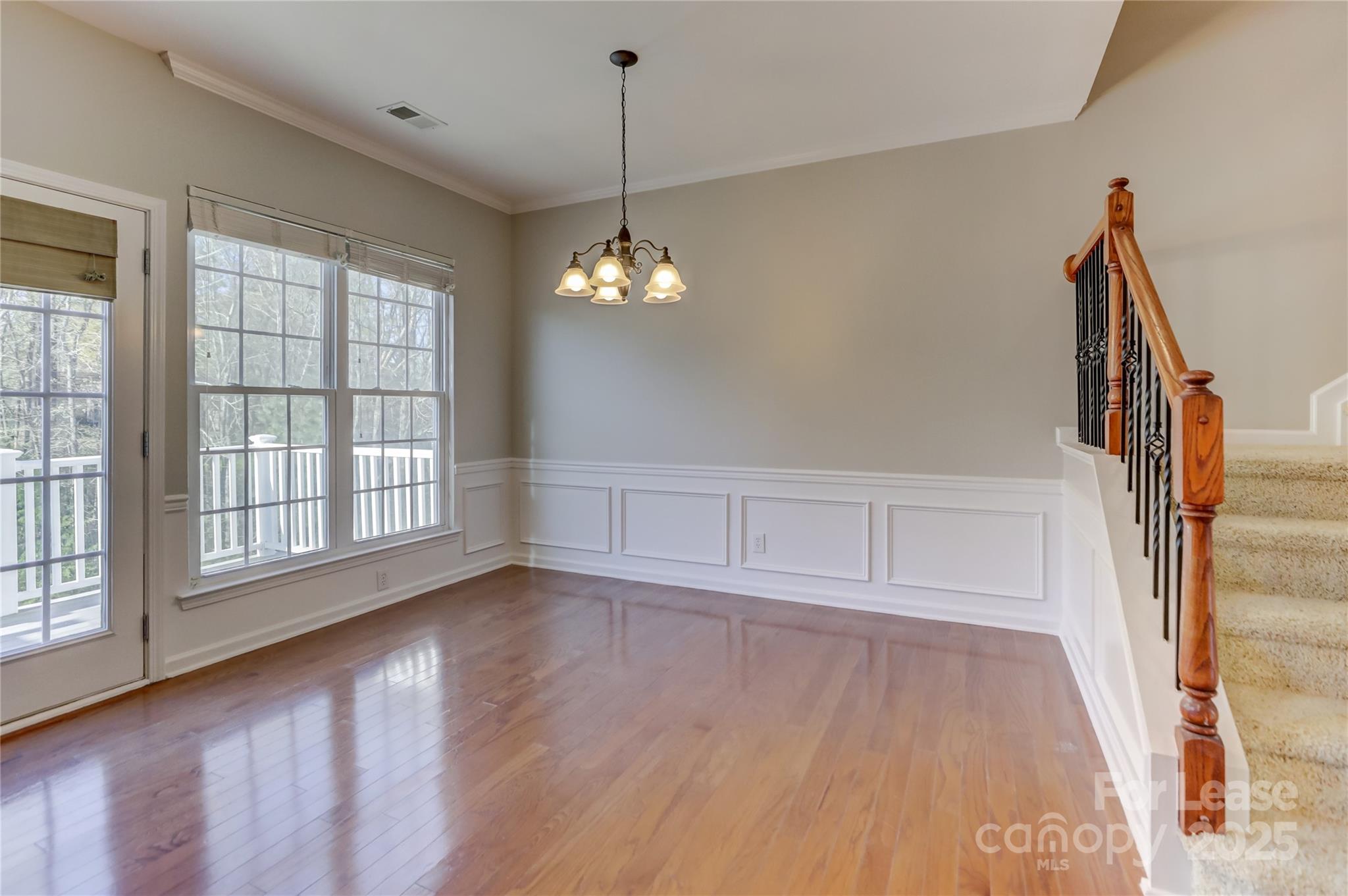 562 6th Baxter Crossing Fort Mill, SC 29708 - Photo 18 of 47 a view of wooden floor and windows in a room