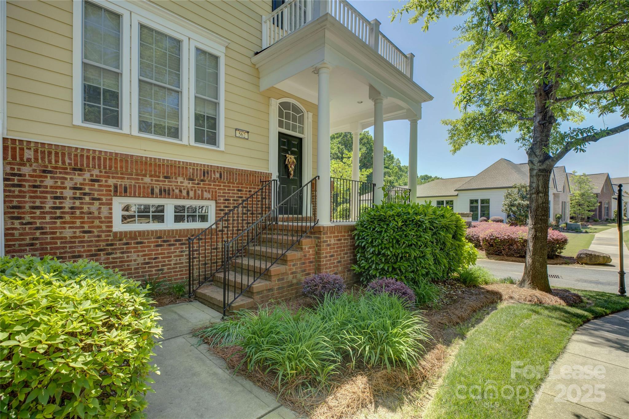 562 6th Baxter Crossing Fort Mill, SC 29708 - Photo 4 of 47 a front view of a house with a garden
