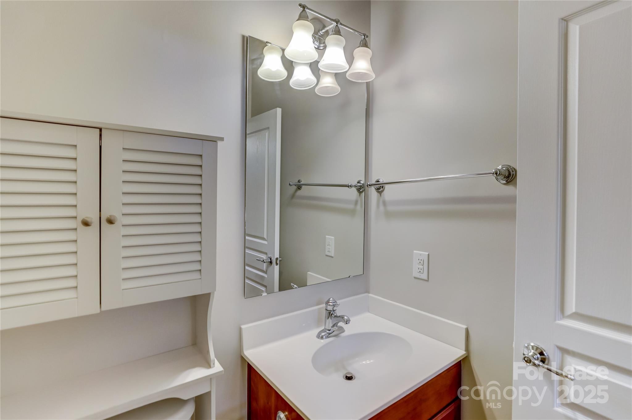 562 6th Baxter Crossing Fort Mill, SC 29708 - Photo 43 of 47 a bathroom with a sink a mirror and a light fixture