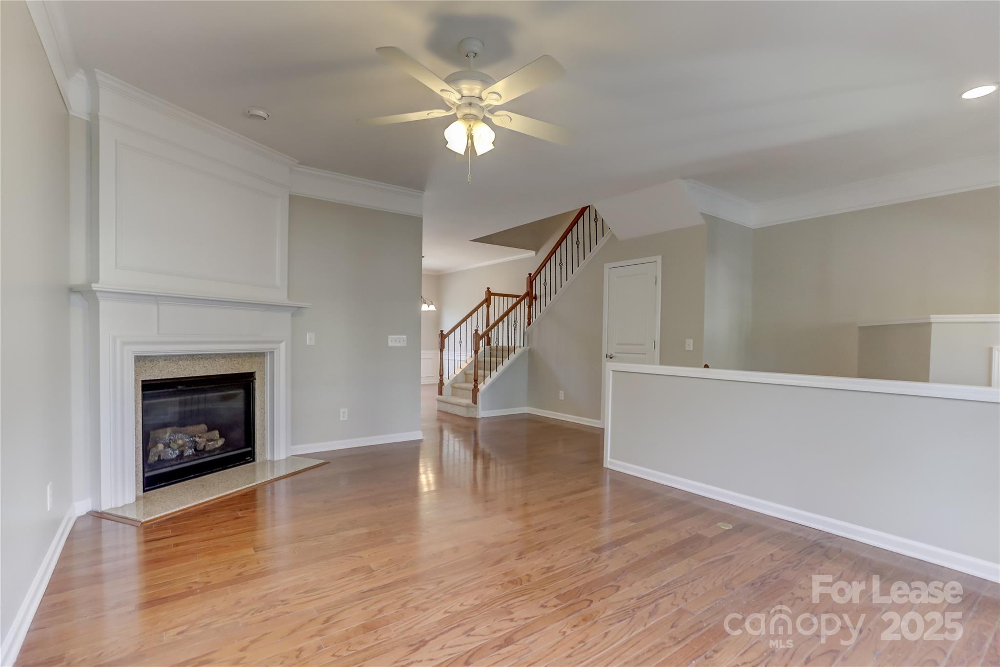 562 6th Baxter Crossing Fort Mill, SC 29708 - Photo 9 of 47 a view of an empty room with wooden floor fireplace and a window