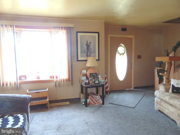 a living room with furniture a window and a fireplace