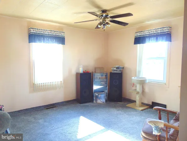 a view of a livingroom with furniture and a window