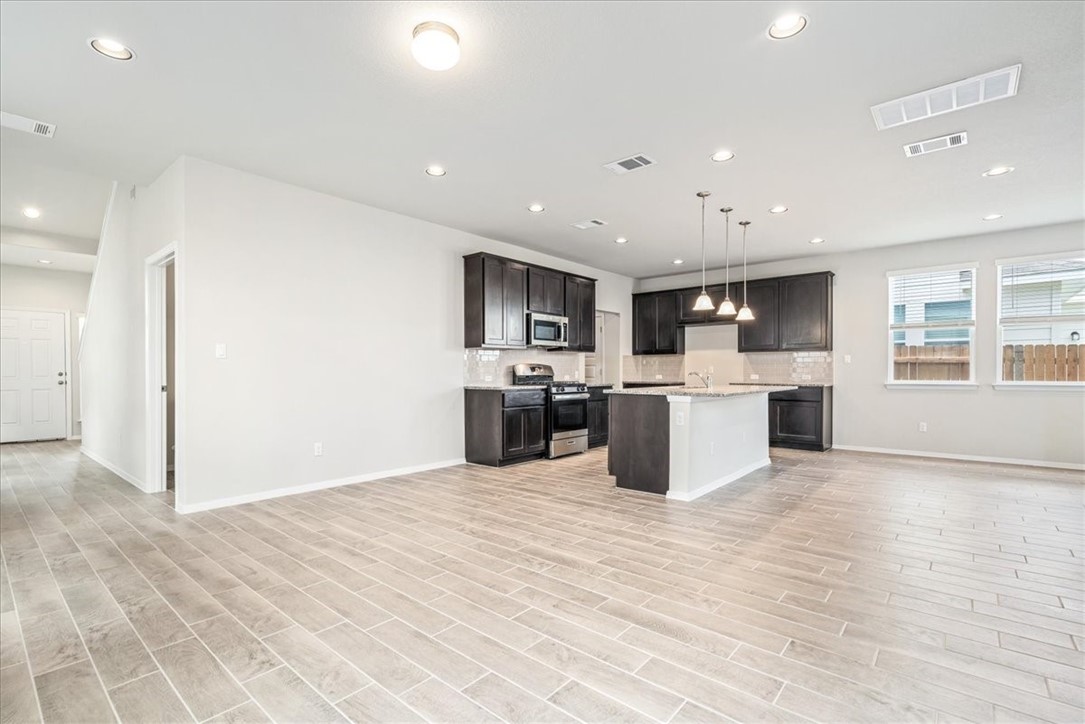 169 Heather Glen Way Maxwell, TX 78656 - Photo 11 of 40 a large kitchen with stainless steel appliances lots of counter top space cabinets and a window