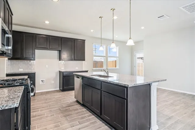 a kitchen with a sink stove and refrigerator