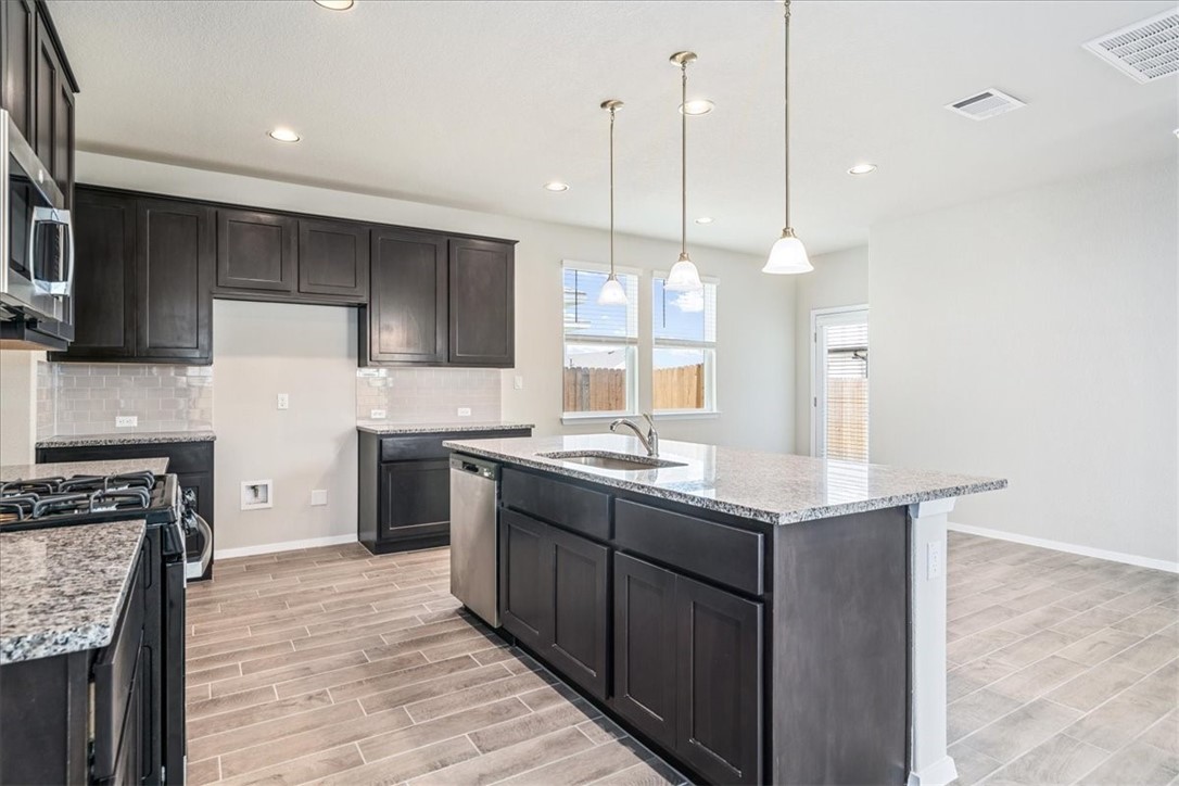 169 Heather Glen Way Maxwell, TX 78656 - Photo 13 of 40 a kitchen with a sink stove and refrigerator