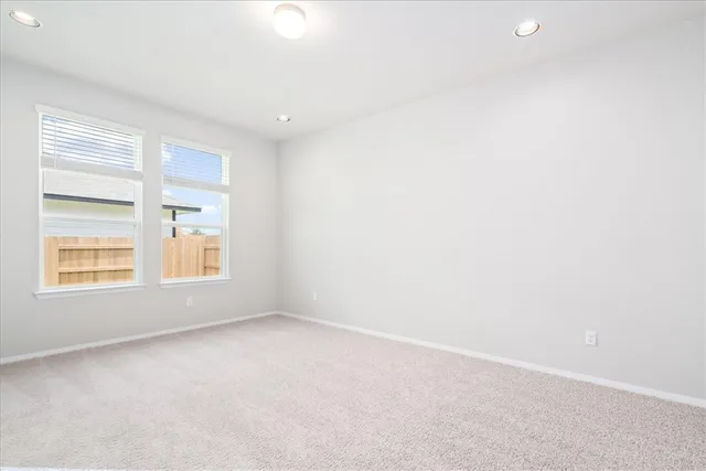 an empty room with windows and closet