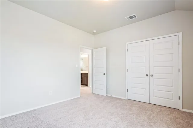 a view of an empty room and a window