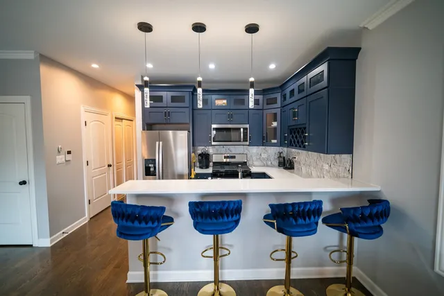 a large kitchen with a table and chairs