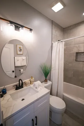 a bathroom with a sink toilet and tub