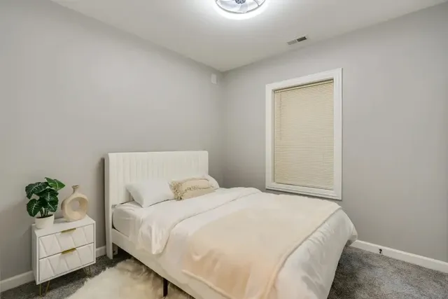 a bedroom with a bed and a couch