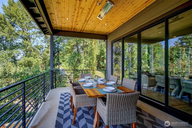 a view of a patio with a table chairs and a backyard