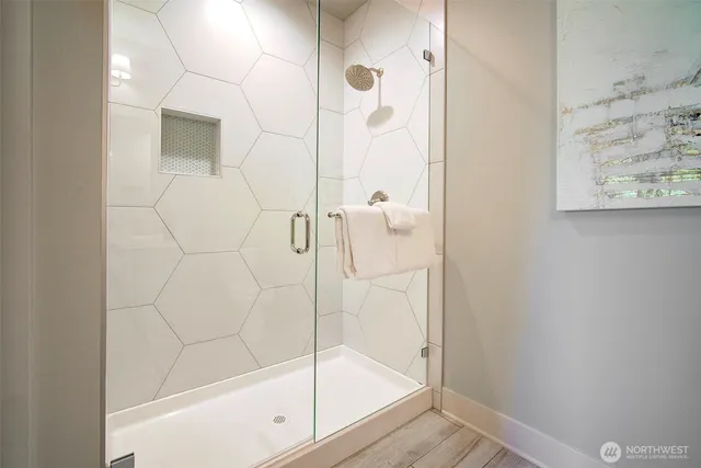 a bathroom with a glass shower door
