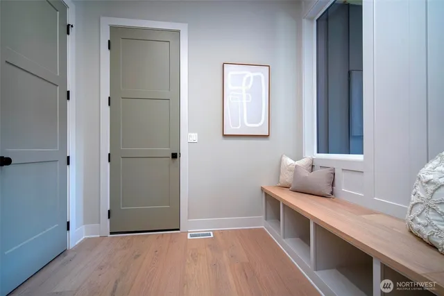 a hallway with bed and wooden floor