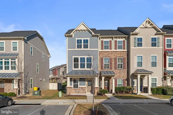 a front view of a residential apartment building with a yard