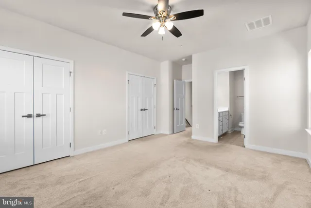 a view of empty room with ceiling fan