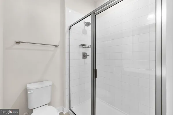 a view of staircase with lots of frames on wall and wooden floor