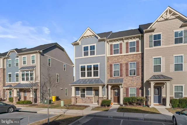 a front view of a house with outdoor seating
