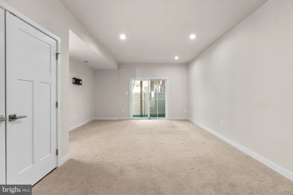 an empty room with windows and closet