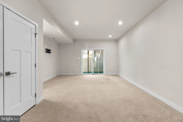 an empty room with windows and closet