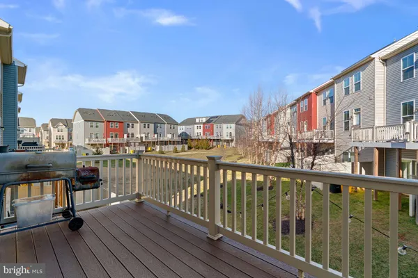 a view of a house with couches chairs and fire pit