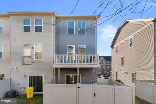 a view of a patio with dining table and chairs with wooden floor